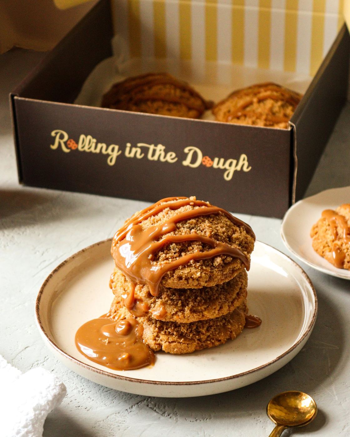 A stack of apple crumble cookies with caramel