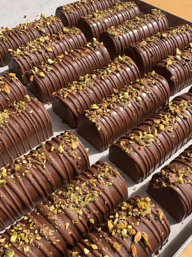 A tray of pistachio chocolate logs