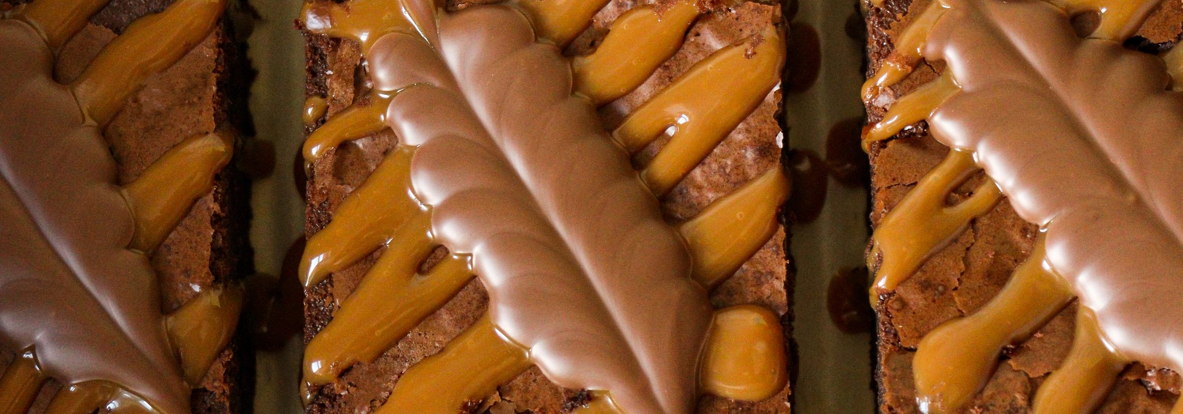 Brownies from above, each topped with a chocolate leaf and caramel