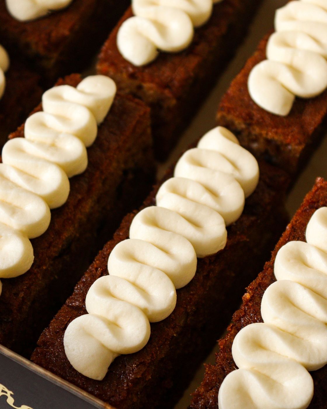 Carrot cake slices with hand-piped frosting