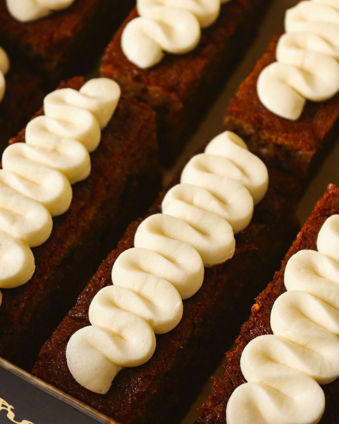 Carrot cake slices with piped frosting