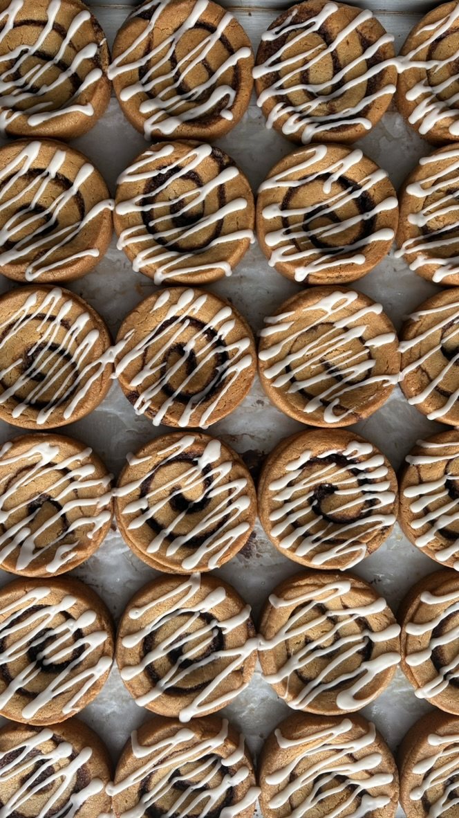 Cinnamon roll cookies with a white icing drizzle